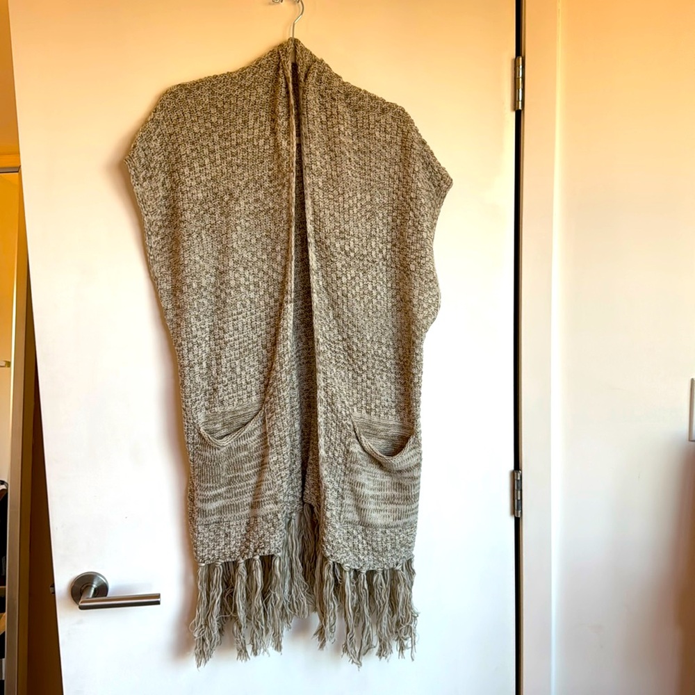 Long oversized sweater vest with great fringe detailing two deep pockets